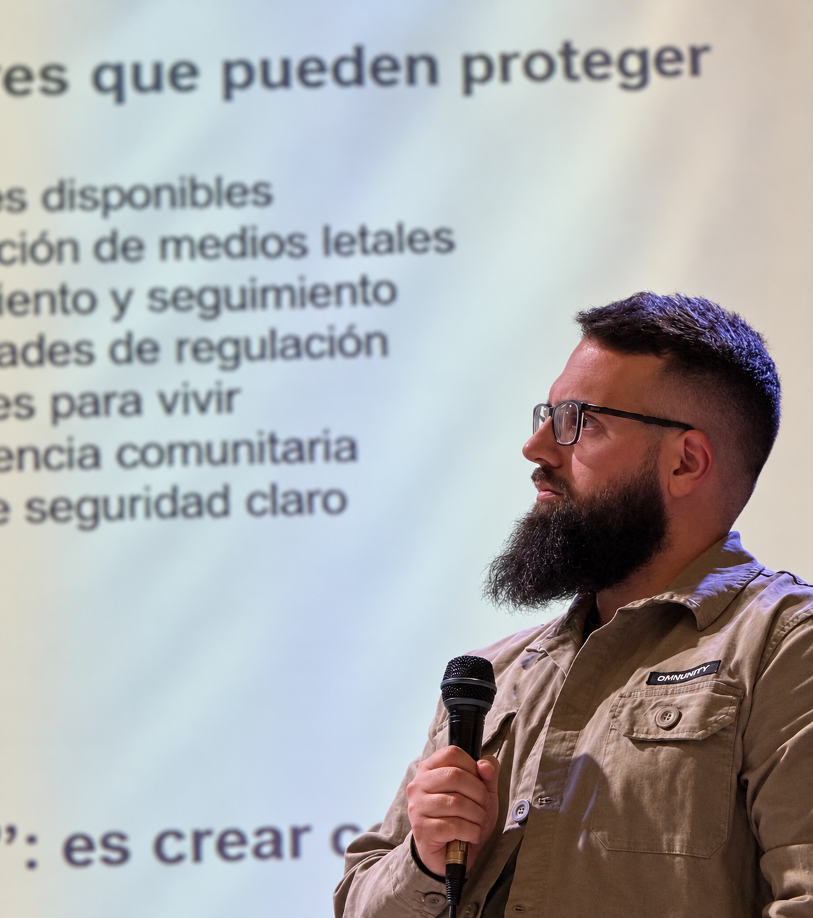 Mauro Moa participando en una charla, con un micrófono en la mano